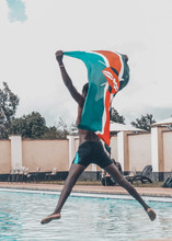 Partriotic Kenyan Dive Into Pool Flying Kenyan Flag