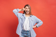 © arthurhidden - Funny, carefree girl having fun isolated on a red background with open mouth