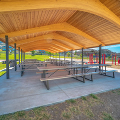 Wall Mural - Square Park pavilion playground and basketball court gainst homes mountain and blue sky