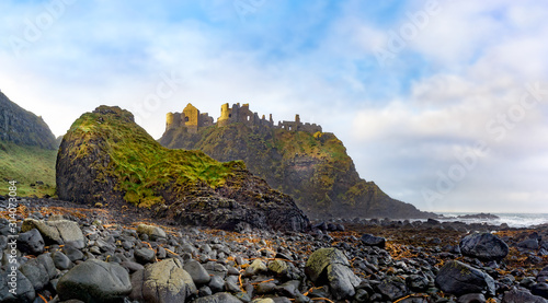 Photographie Ruined medieval Dunluce Castle on the cliff dramatic sky