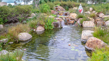Panorama Small Waterfall Or Cascade In A Landscaped Garden
