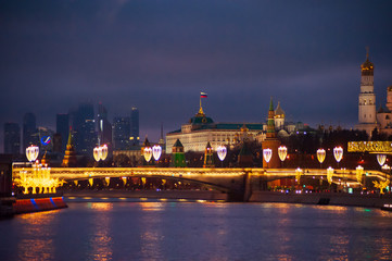 Wall Mural - Moscow, Russia - January 03, 2020:   View of the Moscow Kremlin and the Moskva river in the evening with Christmas illumination.