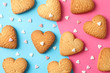 © Atlas - Heart shaped cookies on color background with hearts, top view