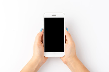 woman’s hand with blue nails holding mobile phone with empty screen isolated on white background. to