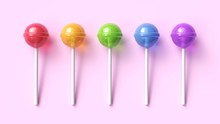 Set Of Five Colorful Sweet Lollipops On Pink Pastel Background