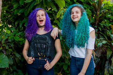 Young colored hair women having fun and making faces.