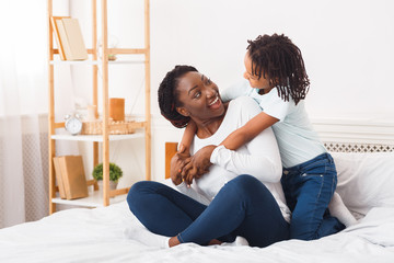 Wall Mural - African american family cuddling in the bed