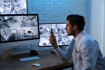 Male security guard with portable transmitter at workplace