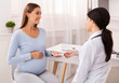© Prostock-studio - Therapist Giving Pregnant Woman Prescribed Medicines Sitting In Office