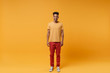 © ViDi Studio - Smiling young african american guy in casual clothes posing isolated on yellow orange wall background, studio portrait. People sincere emotions lifestyle concept. Mock up copy space. Looking camera.