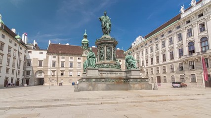 Wall Mural - Statue of Kaiser Franz Joseph I timelapse hyperlapse at the Hofburg Palace in Vienna. It is located in the courtyard of Hofburg Palace. Blue sky at sunny day