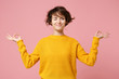 Funny young brunette woman girl in yellow sweater posing isolated on pastel pink background. People lifestyle concept. Mock up copy space. Hold hands in yoga gesture relaxing meditating looking aside.