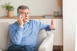 © Prostock-studio - Senior Man Talking On Cellphone Sitting On Couch At Home