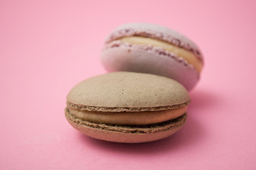 Wall Mural - Closeup of french macarons on pink background