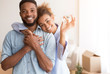 Couple Holding New Home Key Hugging Standing In Own House