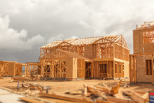 Wood Home Framing Abstract At Construction Site With Stormy Clouds Behind