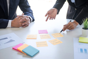 Business team executive accounting analyzing and calculation on valuation data investment fund looking at report, sticky note paper and having a consultation, Wealth Management and investment concept