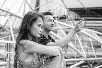 Sticker - Young asian man showing the city to her woman