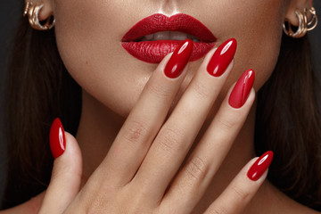 beautiful girl with a classic make-up and red nails. manicure design. beauty face.