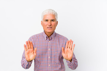 Wall Mural - Senior caucasian man isolated rejecting someone showing a gesture of disgust.