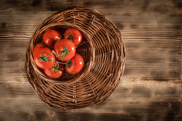 Fresh tomatoes in a wicker basket.