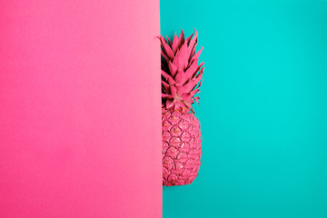 Wall Mural - Color pineapple on pink and blue background. Surreal minimalistic art