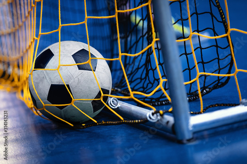 Indoor Soccer Futsal Ball On Goal With Net And Blue Background. Indoor Football Background
