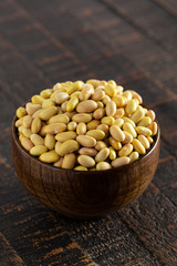 Wall Mural - Bowl of Dry Mayocoba Beans on a Rustic Wooden Table