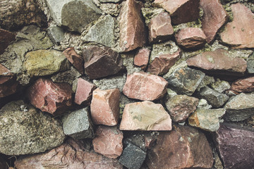 Old rock granite stone board wall / floor. House reparation, housework exterior and interior design wallpaper, background in faded light retro hipster colors.