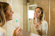 © Novak - Beauty young woman cleaning teeth in bathroom