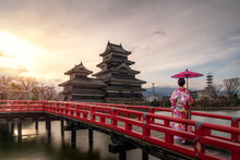 Young Asian Woman Wearing Kimono Japanese Tradition Dressed Sightseeing At Matsumoto Castle During Cherry Blossom (Sakura) Is One Of The Most Famous Sights In Matsumoto, Nagano, Japan.