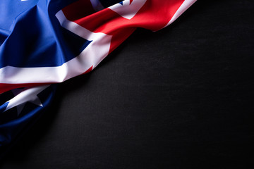 Australia day concept. Australian flag with the text Happy Australia day against a blackboard background. 26 January.