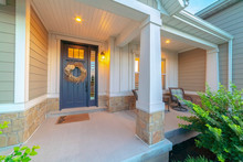 Front And Sidelight Of Home With Front Porch And Wood Siding Exetrior Wall