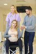pregnant woman in pain sitting on a wheelchair
