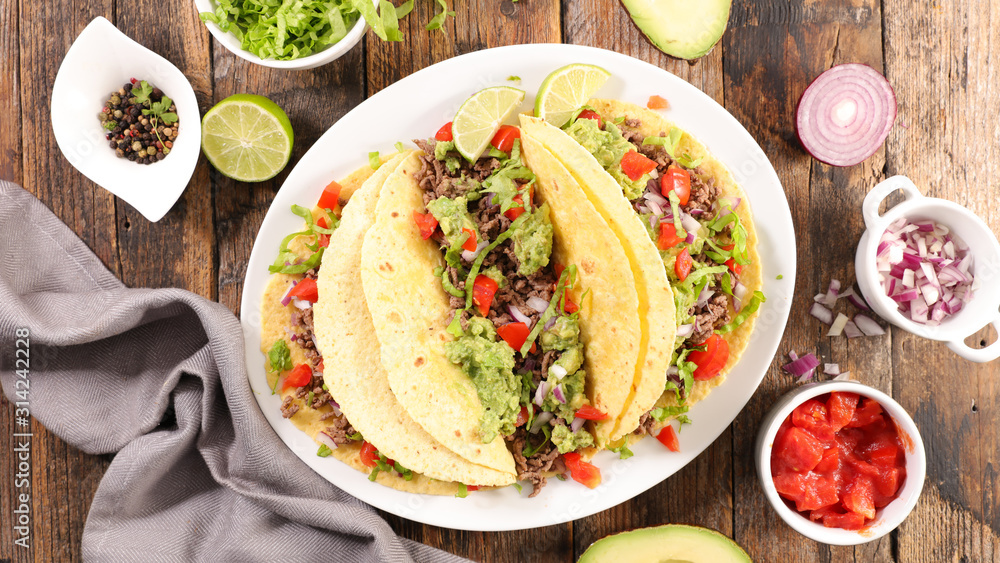 tacos with guacamole, beef, tomato and cheese- tortilla bread - obrazy, fototapety, plakaty 