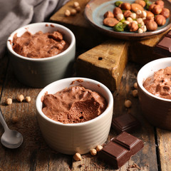 Wall Mural - delicious vegan creamy chocolate mousse on wood background