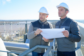 two workers in factory outdoors