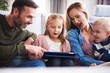 Surprised parents with children looking at tablet