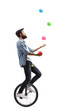 © Ljupco Smokovski - Man riding a unicycle and juggling with balls