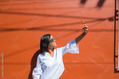 Cuadros en Lienzo beautiful African-American young woman selfie in the city