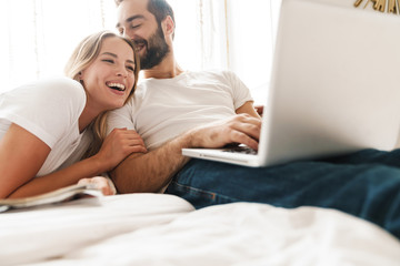 Beautiful young couple relaxing on bed