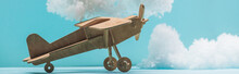 Wooden Toy Plane Among White Fluffy Clouds Made Of Cotton Wool Isolated On Blue, Panoramic Shot