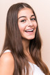 © Asier - Young cute caucasian woman against a beige background