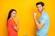 © deagreez - Profile photo of funny two people guy lady celebrating competition winning sportive champions wear casual blue orange t-shirts jeans isolated yellow color background