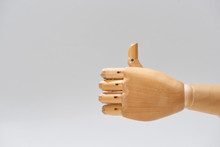 Hand Of Wooden Doll With Thumb Up Gesture Isolated On Grey