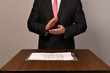 a man in a suit claps his hands
