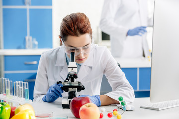 selective focus of molecular nutritionists using microscope in lab