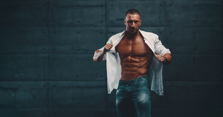 Wall Mural - Handsome Muscular Men in White Shirt Exposing His Muscular Torso