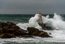 Dramatic Seascape. Huge Waves Hit The Lighthouse During Severe Sea Storm. 