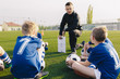 © matimix - Young Coach Explaining Soccer Positions and Match Tactics to Youth. Kids Football Team Coaching. Children on Soccer Training